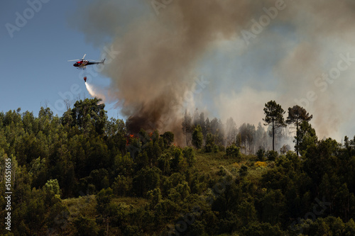 Firefighter Helicopter fighting against a Forest Fire during Day in Braga, Portugal.