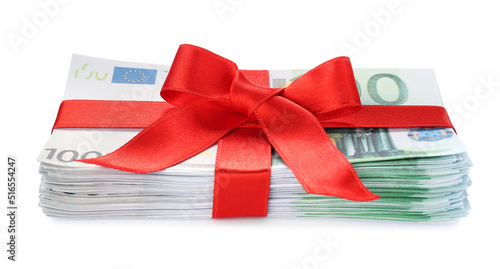 Euro banknotes tied with red ribbon isolated on white. Money and finance
