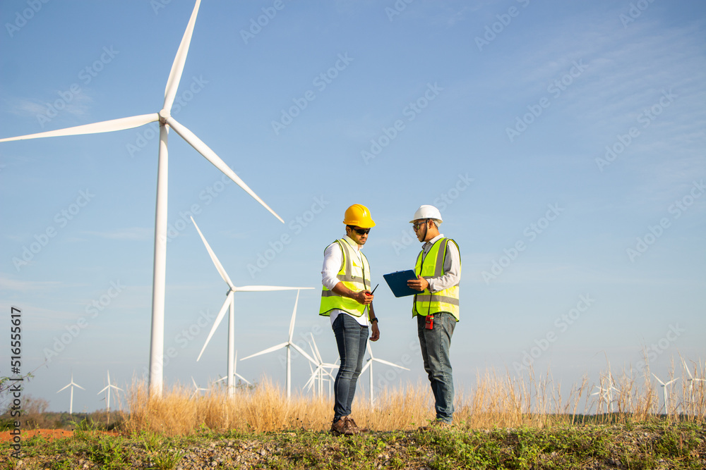 engineer team working in wind turbine farm. Renewable energy with wind generator by alternative energy concept. engineer team working in wind turbine farm. Renewable energy with wind generator by alternative energy concept.