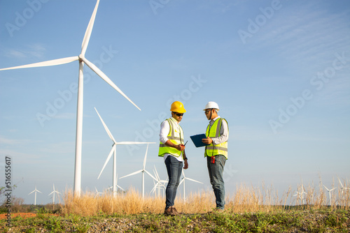 engineer team working in wind turbine farm. Renewable energy with wind generator by alternative energy concept. photo
