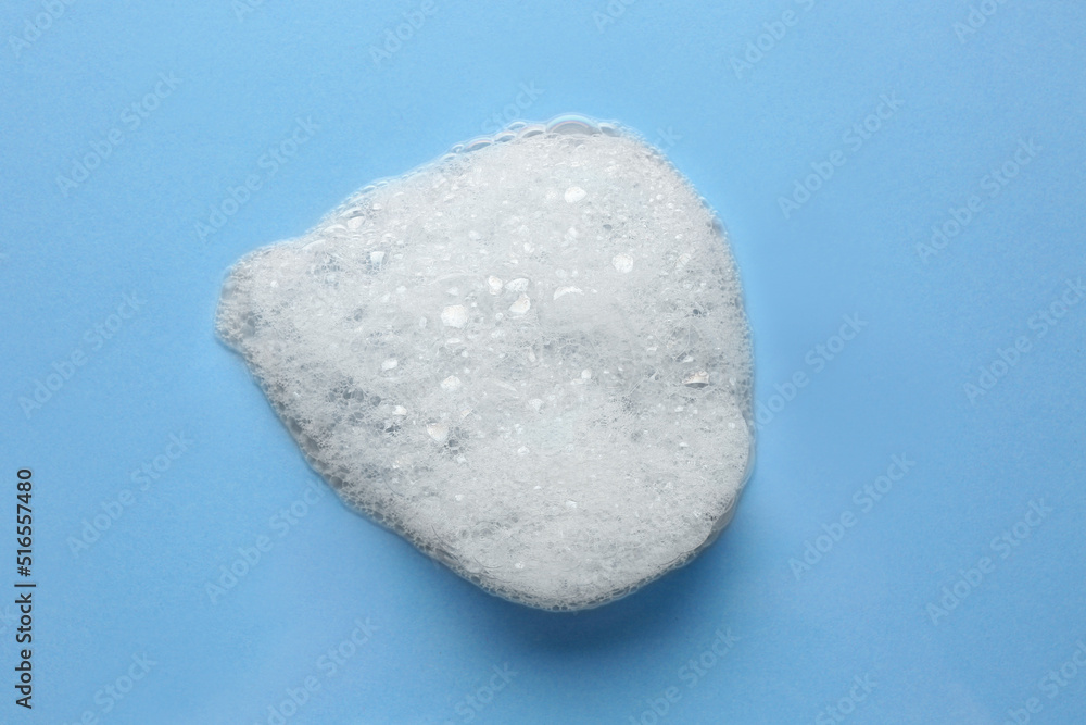 Drop of bath foam on light blue background, top view Drop of bath foam on light blue background, top view