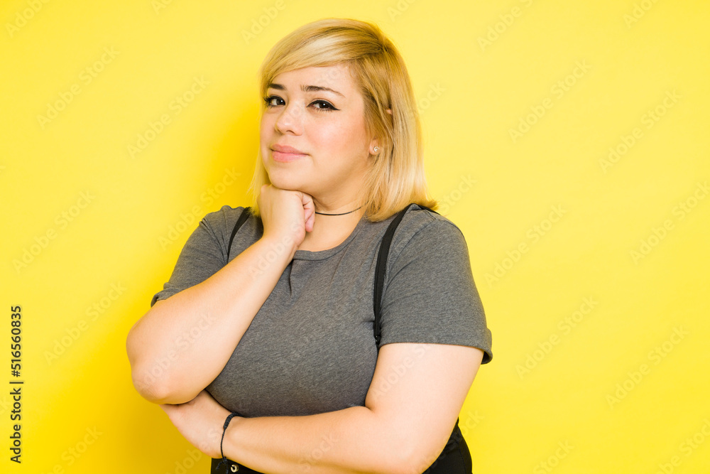 Confident young fat woman with blond dyed hair in a studio Confident young fat woman with blond dyed hair in a studio