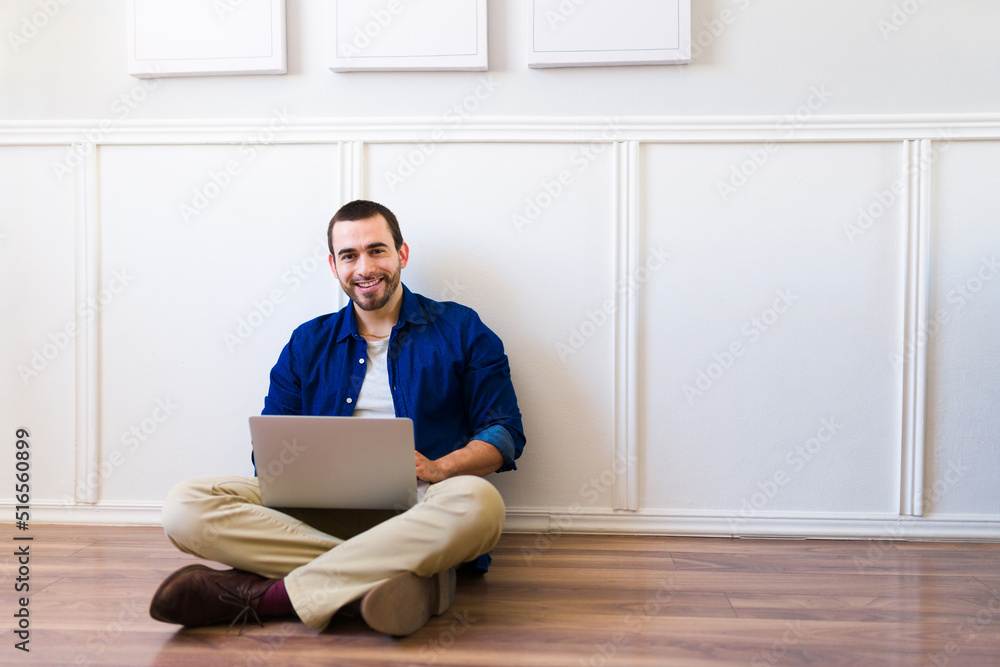 Attractive man with a laptop enjoying working from home Attractive man with a laptop enjoying working from home