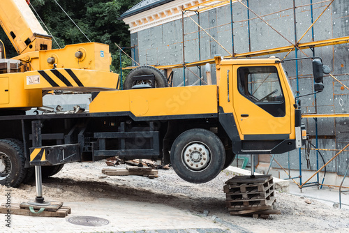 Extended hydraulic outrigger to increase crane stability. Truck crane operation in difficult conditions