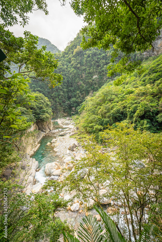 Beautiful natural scenic of river inside the valley with green forest covered.
