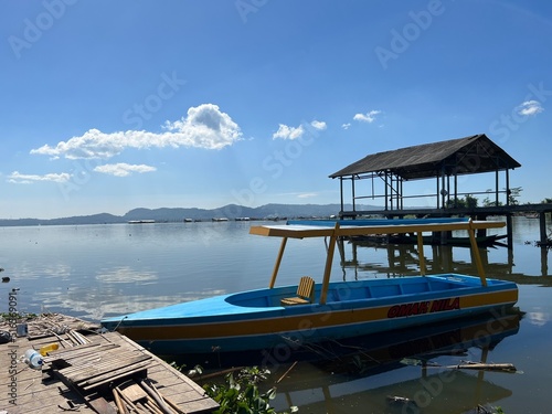 Beautiful Calm Water Reflection Lake and Fisherman working fishing on Boats with Blue Sky and Sunny Weather Clear Horizon