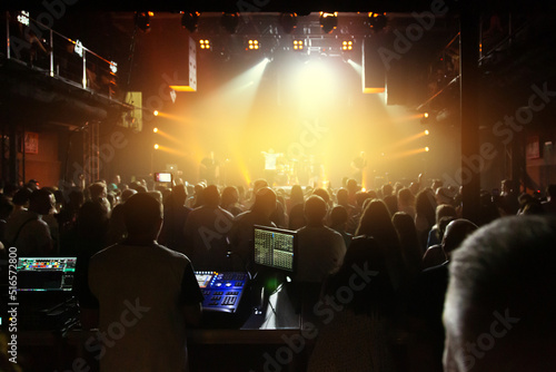 Crowd of spectators in front of the stage at a concert of a popular band in the concert club. © Roman Rvachov