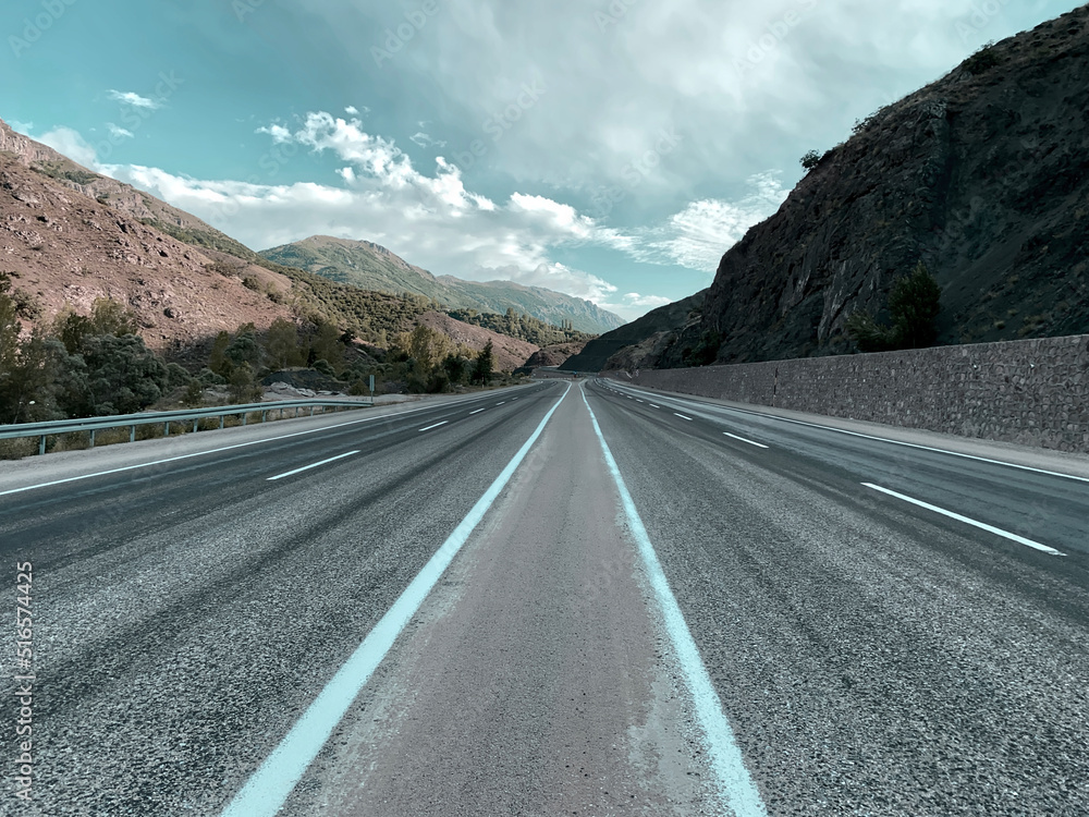 Naklejka premium Colorful road highways. Beautiful calm route. Holiday vacation adventure. No people road with clouds. Creative colors.
