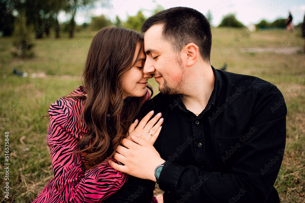 Fototapeta premium Young couple in love outdoor.Stunning sensual outdoor portrait of young stylish fashion couple posing in summer