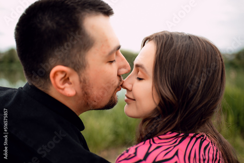 Young couple in love outdoor.Stunning sensual outdoor portrait of young stylish fashion couple posing in summer