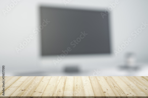 Empty office wooden table with empty space on modern workplace with computer background, close up, mockup © Pixels Hunter