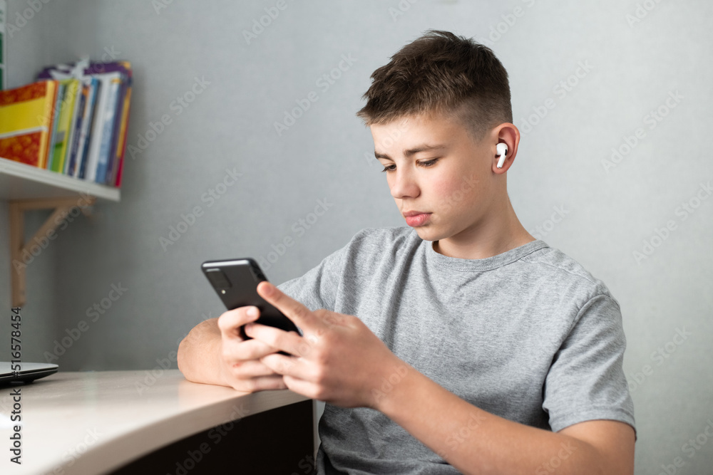 teenage boy using smartphone for study or communication, looking at mobile screen teenage boy using smartphone for study or communication, looking at mobile screen