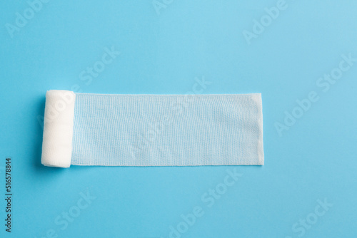 First aid, injury protecting wrapping and wound dressing concept clean cotton gauze bandage isolated on colorful background with space for sign.