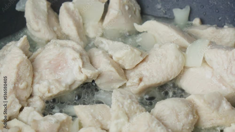 Slices of chopped meat chicken fillet over fried in a frying pan close-up. Selective focus Slices of chopped meat chicken fillet over fried in a frying pan close-up. Selective focus