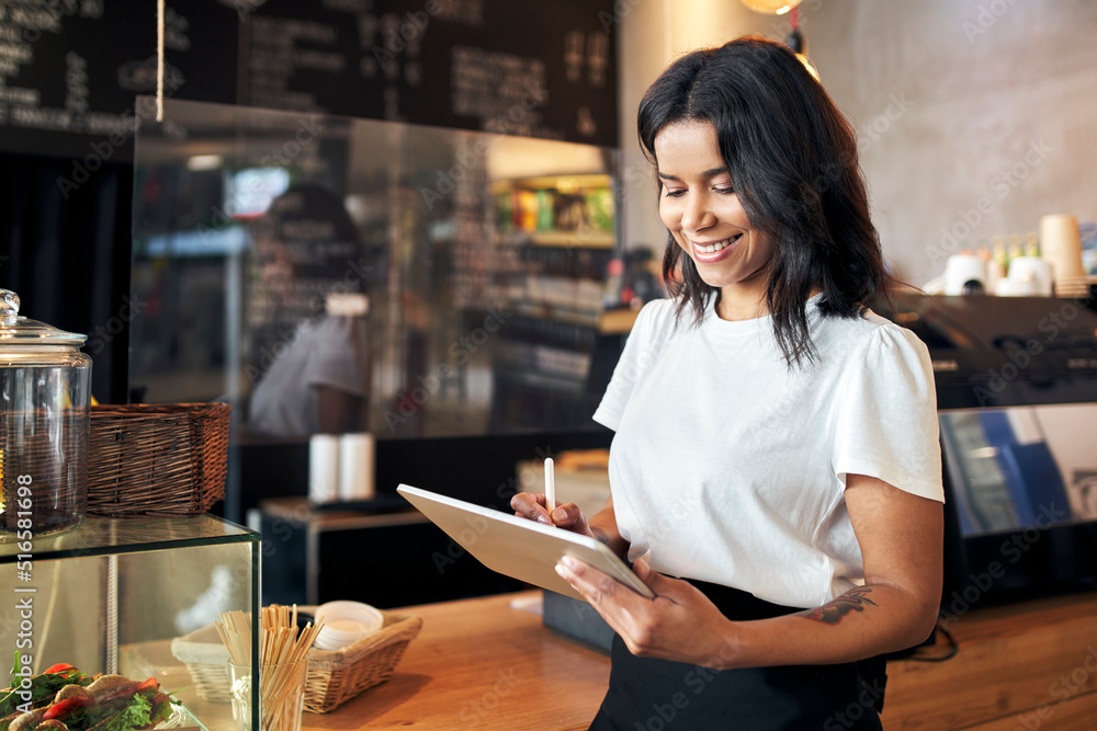 Happy waitress barista using digital tablet at work in cafe, restaurant - obrazy, fototapety, plakaty 
