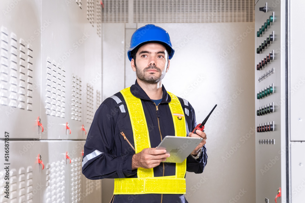 Maintenance engineer inspect relay protection system with laptop tablet ...