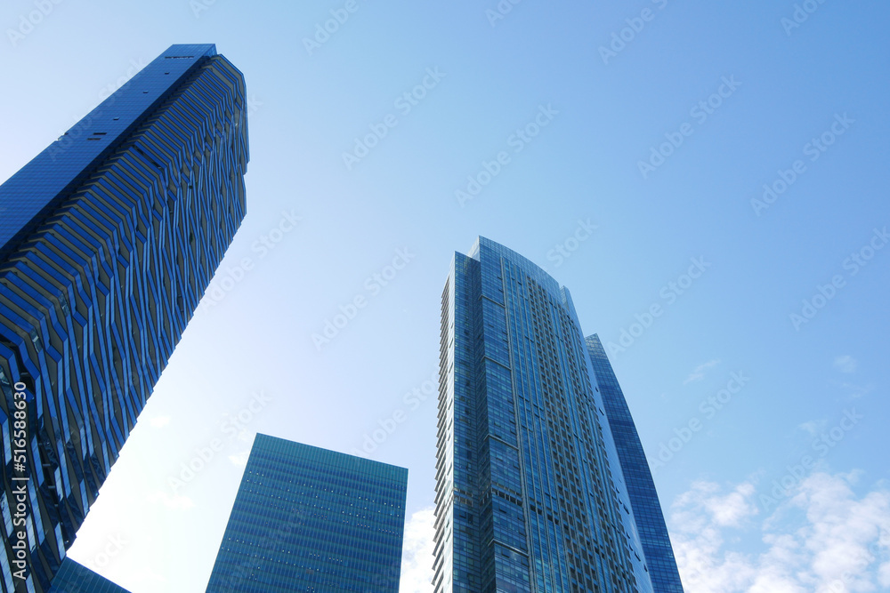 low angle view of singapore city financial buildings against blue sky 