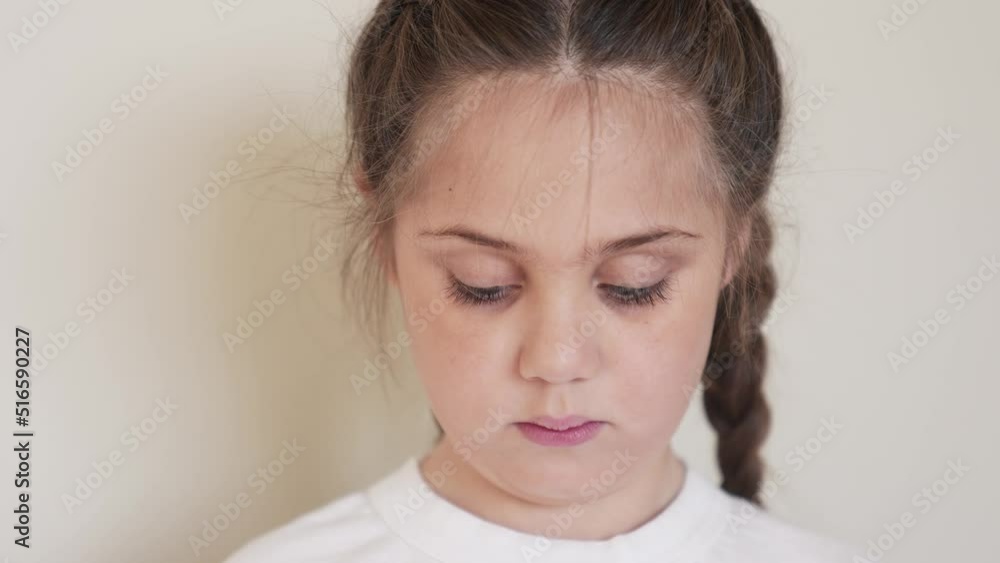 portrait child girl looking at the camera. happy family kid dream concept. baby eyes down then look at the camera and smiles. portrait girl kid indoors close-up funny. smile teeth fell out portrait child girl looking at the camera. happy family kid dream concept. baby eyes down then look at the camera and smiles. portrait girl kid indoors close-up funny. smile teeth fell out