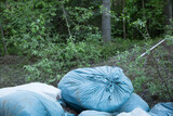 Garbage and pollution. Environmental protection or volunteering for charity, Waste disposal through recycling. Waste is densely deposited in the forest background. Ecological problem concept
