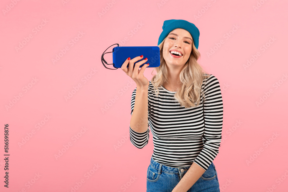 young woman holding music speaker young woman holding music speaker