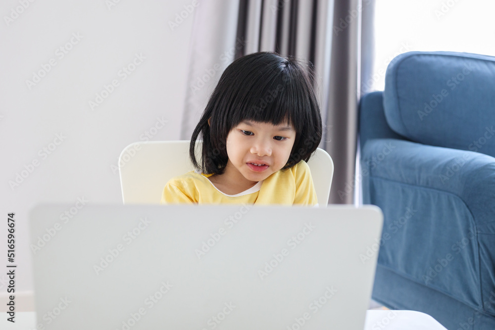 little asian girl student study online using laptop computer at home little asian girl student study online using laptop computer at home