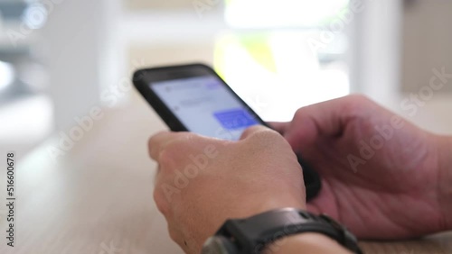 Close up shot of men hand using smart phone for check email for work or sending text SMS short message at home. Mobile wireless digital technology for communication.