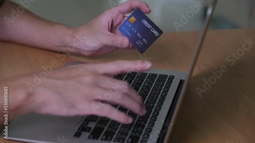Men hand holding credit card and type payment information on keyboard for order online shopping. Internet technology and Digital market place E-Commerce lifestyle concept, Purchase transaction.