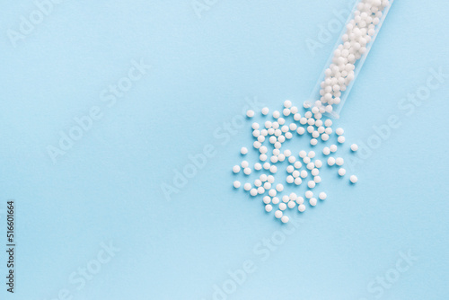 Homeopathic pills and plastic bottle on a blue background. homeopathic medicine 