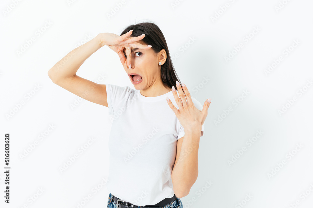 Bad smell, young woman clamped her nose with disgusted expression Bad smell, young woman clamped her nose with disgusted expression
