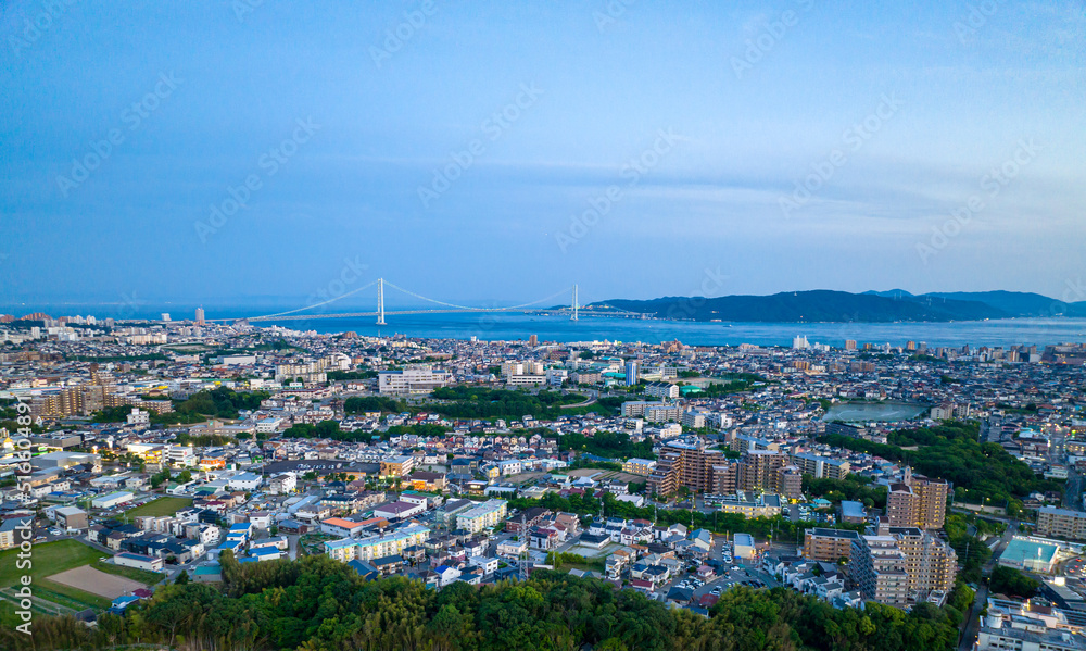 Aerial view of Akashi City and Awaji Island with bridge in distance at blue hour