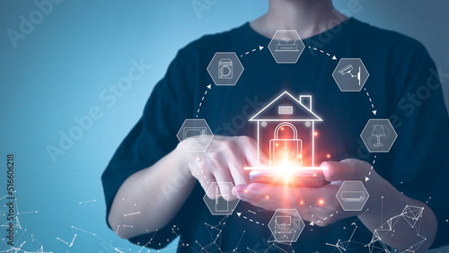 Smart Home Concept People are using their hands to touch their  smart phones to control their home appliances through a wireless internet network.