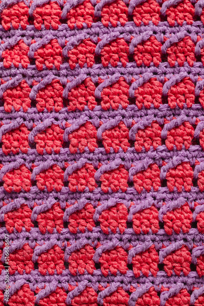 Pink purple seamless knitted texture. Volumetric crochet pattern. Knitted background.