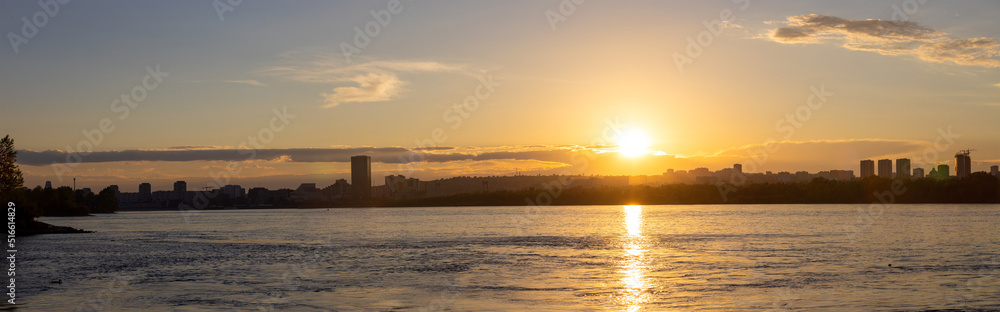 Panoramic view of summer golden sunset over Yenisei river in Krasnoyarsk, Russia