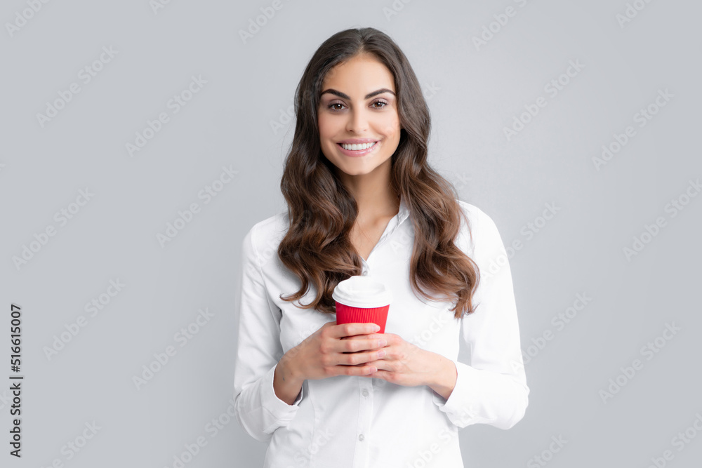 Portrait of a pretty woman holding takeaway coffee cup isolated over gray background. Portrait of a pretty woman holding takeaway coffee cup isolated over gray background.