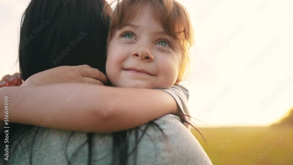 daughter hugging mom. happy family a kid dream concept. mother carries her daughter in her arms walk in the park in nature. child hugging mother neck. mother walks with a child lifestyle in nature daughter hugging mom. happy family a kid dream concept. mother carries her daughter in her arms walk in the park in nature. child hugging mother neck. mother walks with a child lifestyle in nature