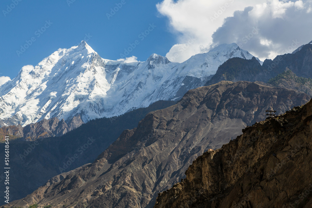 View of snow capped Rakaposhi peak in Karakoram mountain range in Nagar valley. Photo taken on Karakorum highway. Gilgit Baltistan, Pakistan. View of snow capped Rakaposhi peak in Karakoram mountain range in Nagar valley. Photo taken on Karakorum highway. Gilgit Baltistan, Pakistan.