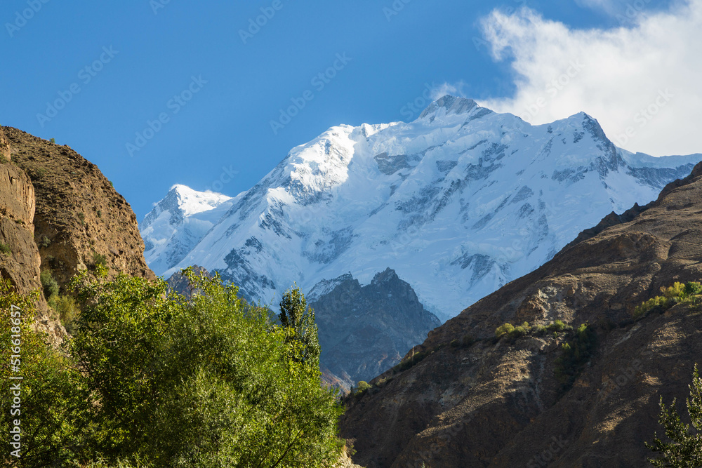 View of snow capped Rakaposhi peak in Karakoram mountain range in Nagar valley. Photo taken on Karakorum highway. Gilgit Baltistan, Pakistan.