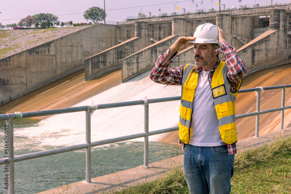 A Dam engineering doing his daily routine inspection work. A Dam engineering doing his daily routine inspection work.