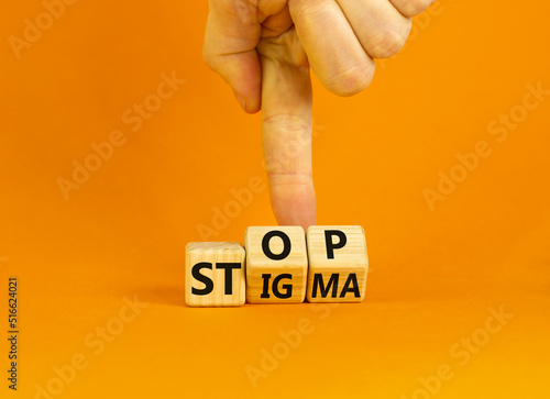 Stop stigma symbol. Concept words Stop stigma on wooden cubes. Businessman hand. Beautiful orange table orange background. Business and Stop stigma concept. Copy space. photo