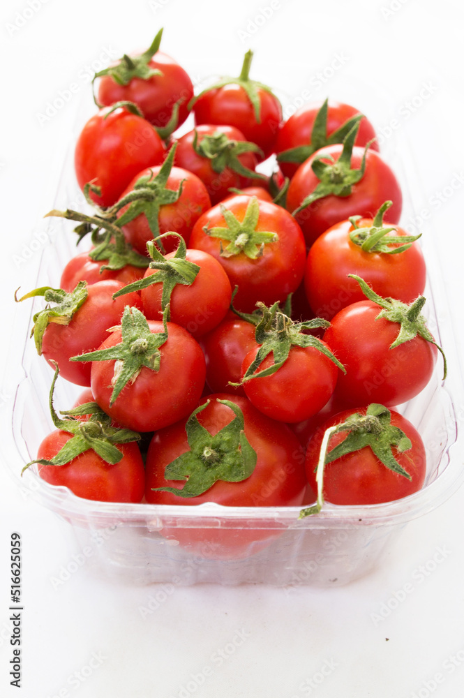 red tomato in a transparent container top view on a white background. Design for supermarket advertising, banner, poster red tomato in a transparent container top view on a white background. Design for supermarket advertising, banner, poster