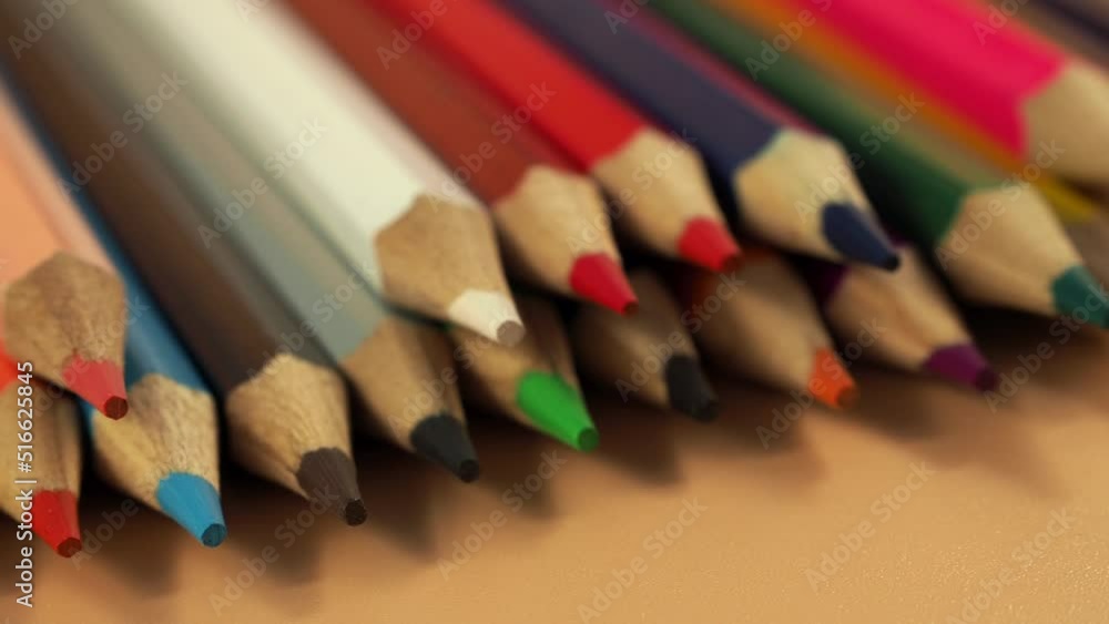 Education and back to school concept. Colored pencils on an orange background. Education and back to school concept. Colored pencils on an orange background.