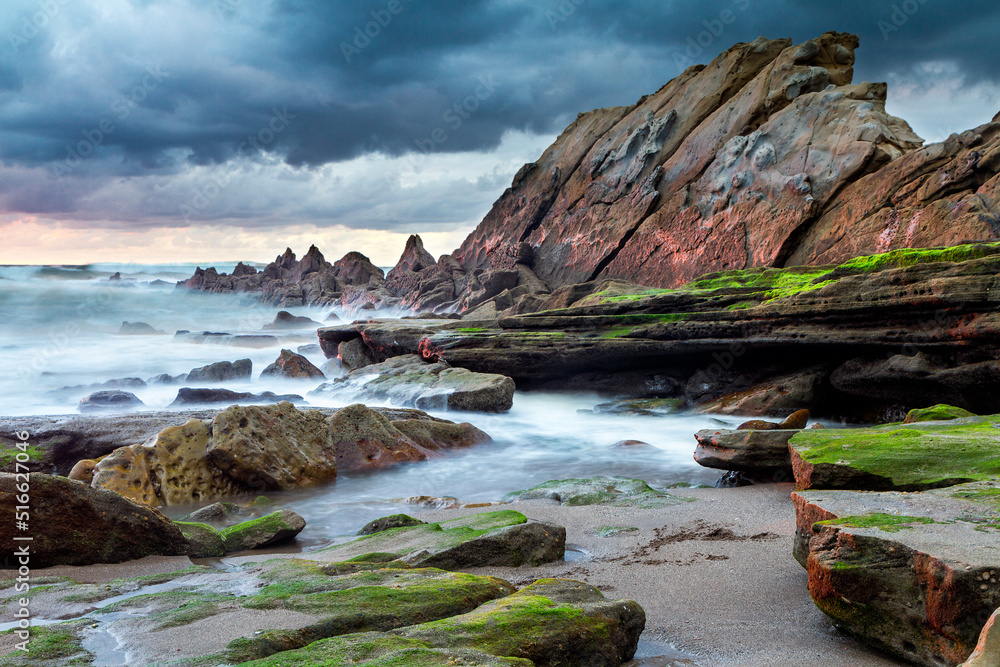 Obraz premium Sunset at Azkorri beach in the coast of Biscay, Basque Country, north of Spain. 