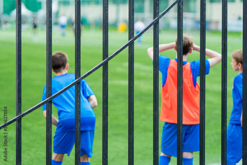 Obraz premium Reserve Soccer Players by football field behind hedge. Teenagers Boys, soccer match