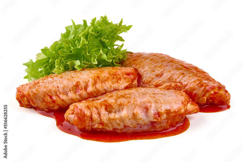 Marinated Buffalo chicken wings in red sauce with lettuce salad leaf, isolated on white background. Marinated Buffalo chicken wings in red sauce with lettuce salad leaf, isolated on white background.