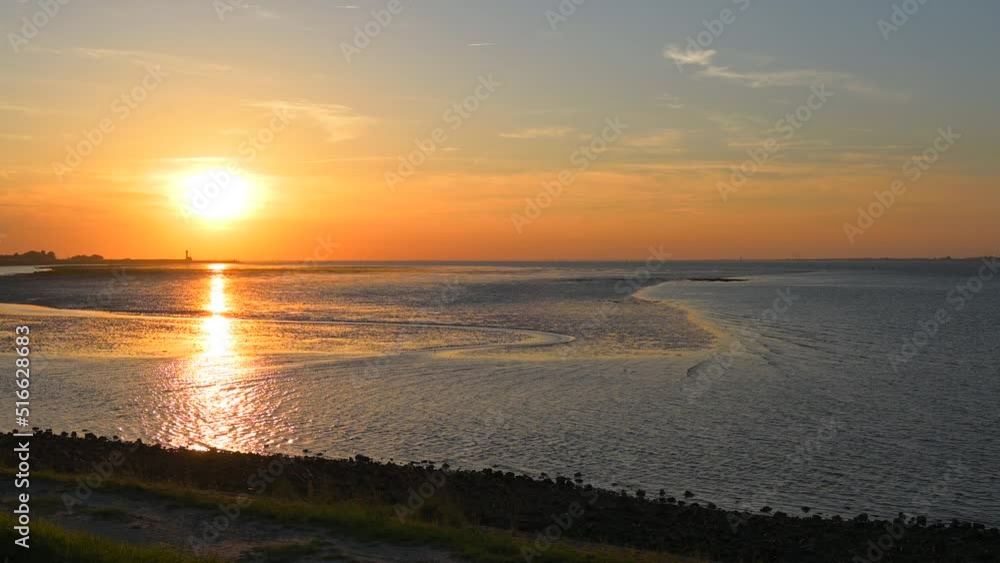 Sunset at the sea at low tide in Yerseke, Netherlands Sunset at the sea at low tide in Yerseke, Netherlands