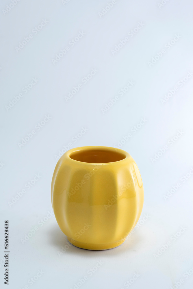 Handmade ceramic cups and bowls of many colors and shapes for tea, coffee and various infusions on a white and sparkling background Handmade ceramic cups and bowls of many colors and shapes for tea, coffee and various infusions on a white and sparkling background