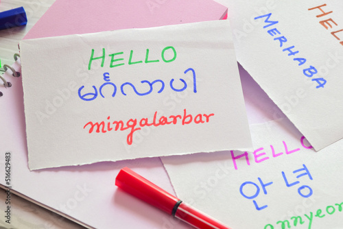 New language learning concept. Handwritten text in white cards Hello in Burmese (mingalarbar), Turkish (Merhaba) and Korean language (annyeong); translation.