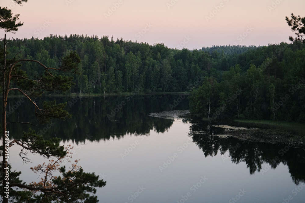 View of river from Parnas rock. Popular tourist route. Reflection of trees in water. Lake Yastrebinoe in summer, Republic of Karelia. The concept of traveling in Russia. View of river from Parnas rock. Popular tourist route. Reflection of trees in water. Lake Yastrebinoe in summer, Republic of Karelia. The concept of traveling in Russia.