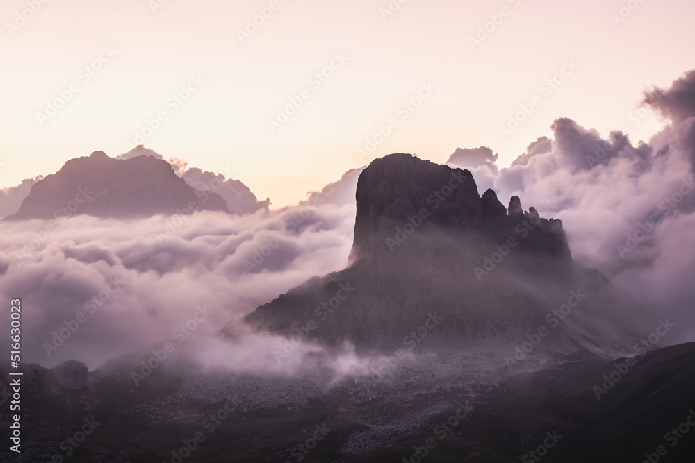 Dramatic shot of a peak emerging from the clouds on the Mondeval Plateau in the Dolomites in Italy.
