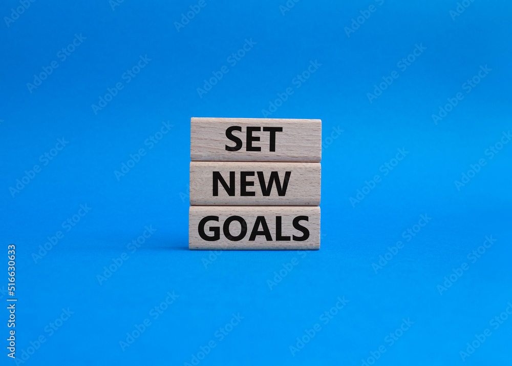 Set New Goals symbol. Wooden blocks with words Set New Goals. Beautiful blue background. Business and Set New Goals concept. Copy space. Set New Goals symbol. Wooden blocks with words Set New Goals. Beautiful blue background. Business and Set New Goals concept. Copy space.